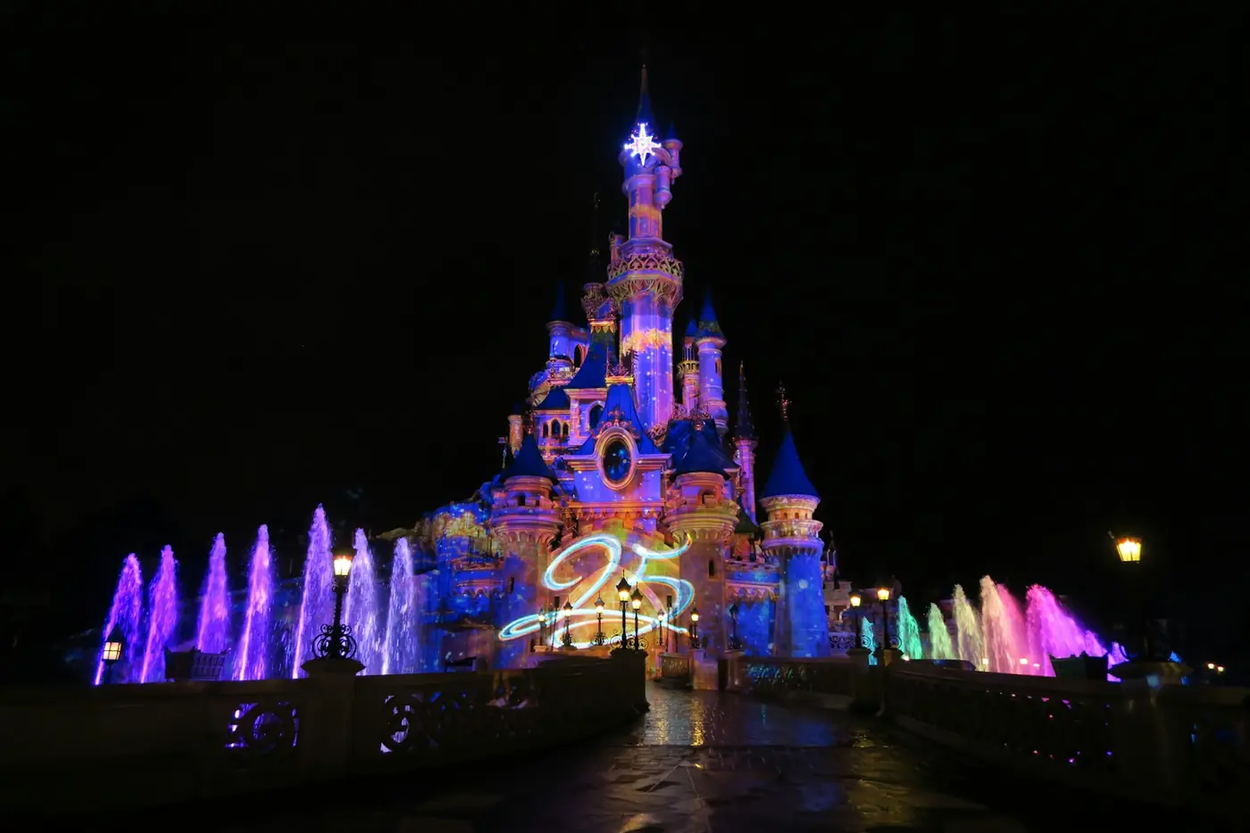 Disneyland castle lit up at night